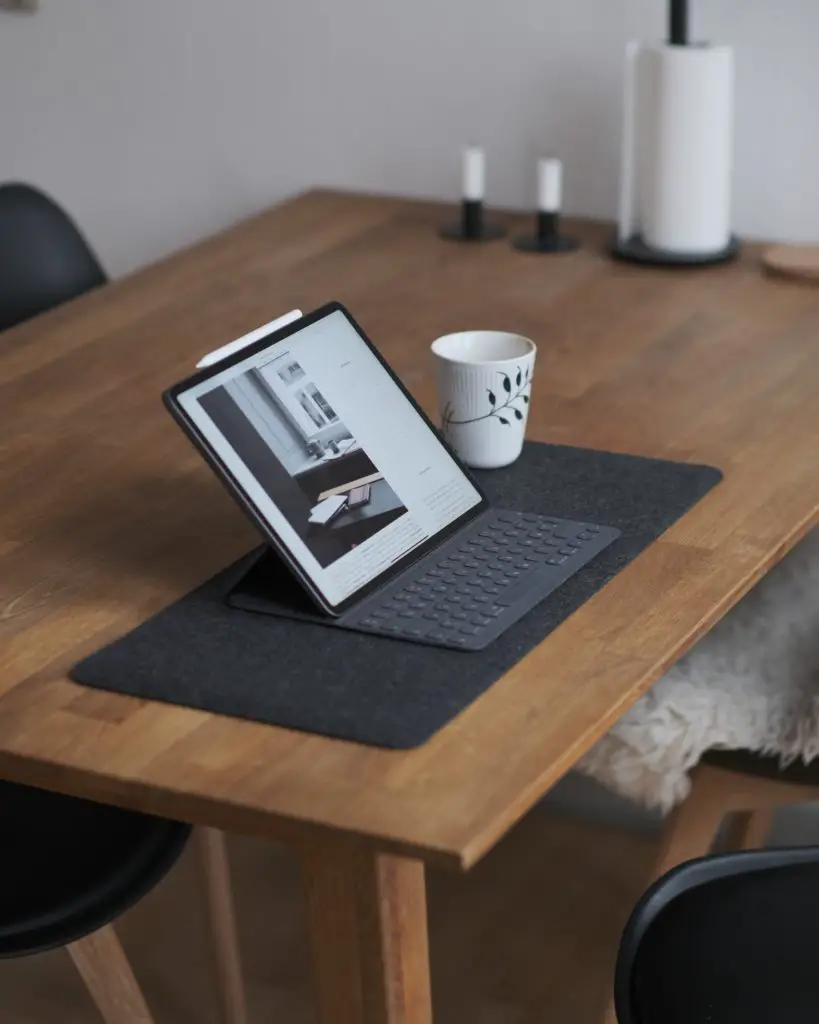 black tablet computer on brown wooden table