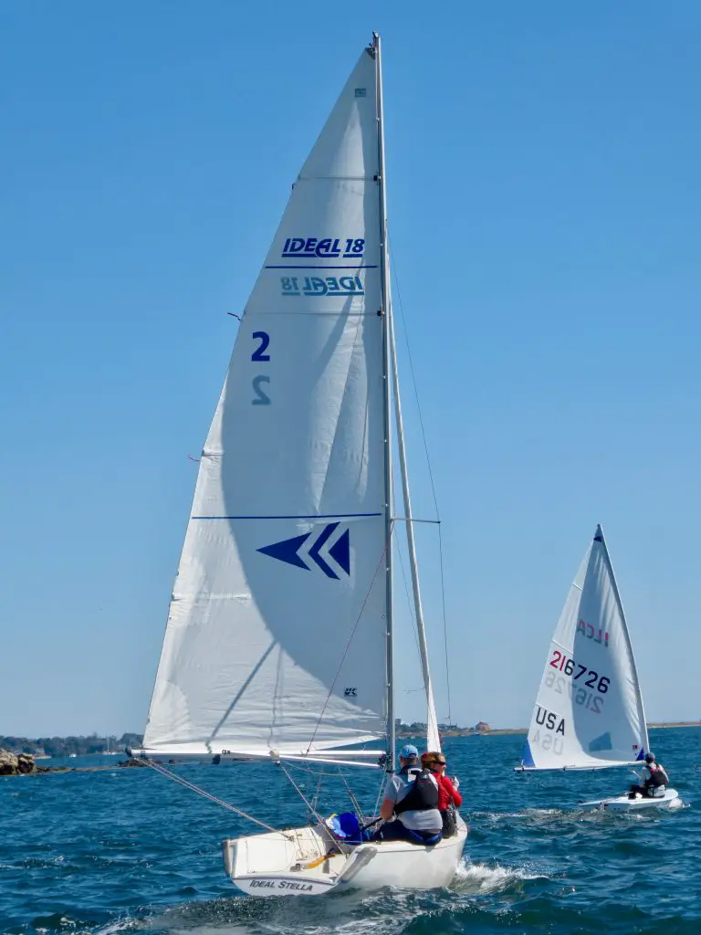 white sail boat on sea during daytime
